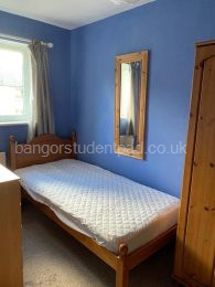 Single bedroom with wardrobe, chest of drawers, desk, chair and shelving unit etc 