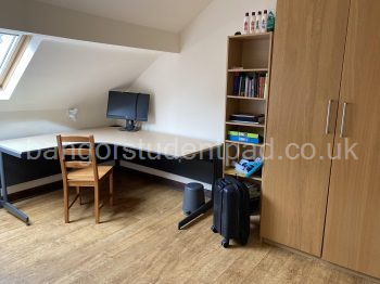 Attic bedroom with large desk & plenty of storage space