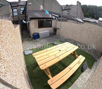 REAR YARD WITH PICNIC BENCH AND WASHING LINE